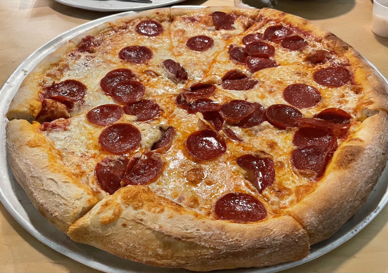 Pepperoni pizza cut into broad slices