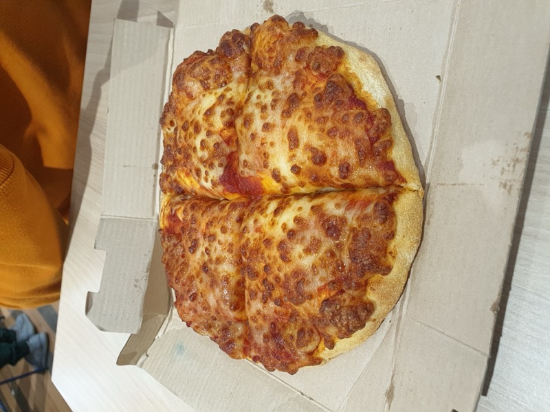 Golden pan-baked pizza with tomato and cheese